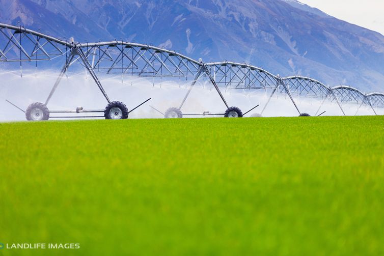 Centre pivot irrigator watering grass, Methven, New Zealand