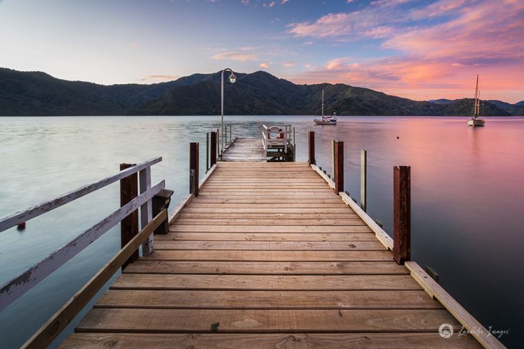 Sunset wharf at Bythells Bay, Marlborough Sounds, New Zealand