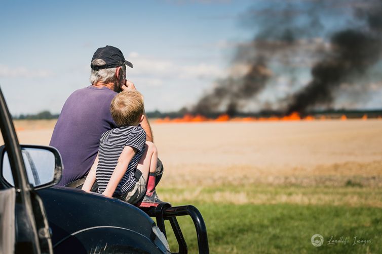 Grandad and grandson watching the controlled burnoff, Methven, Canterbury, New Zealand
