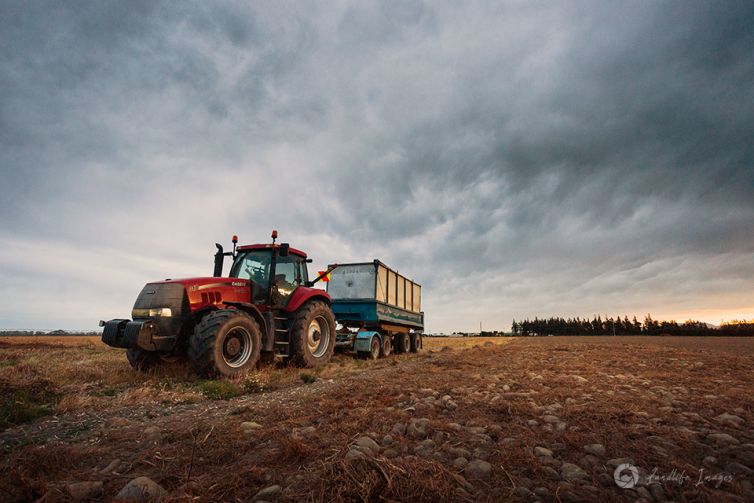 Tractor and trailer in worked field, Canterbury, New Zealand