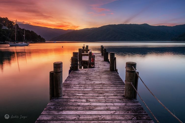 Sunset on the wharf (landscape), Bythells Bay, Marlborough Sounds, New Zealand